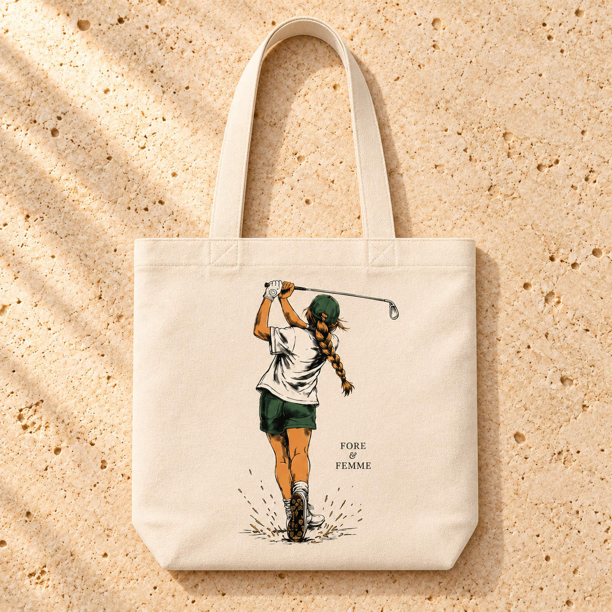 The Swing Tote flat lay, a natural canvas golf tote with swinging golfer artwork by Fore & Femme