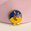 Bunker Babe golf ball marker by Fore & Femme clipped to a pink linen cap