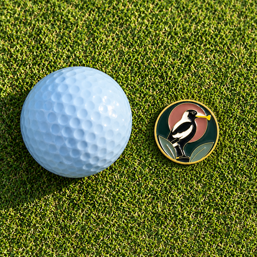 The Course Thief golf ball marker by Fore & Femme on the putting green