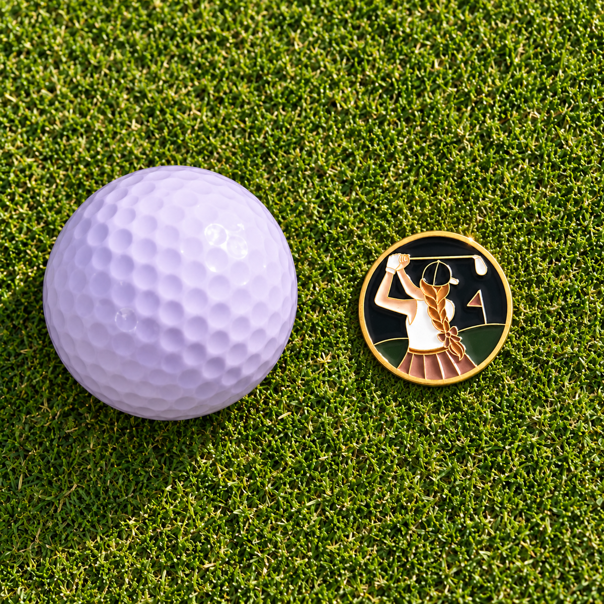 The Follow Through golf ball marker by Fore & Femme on the putting green