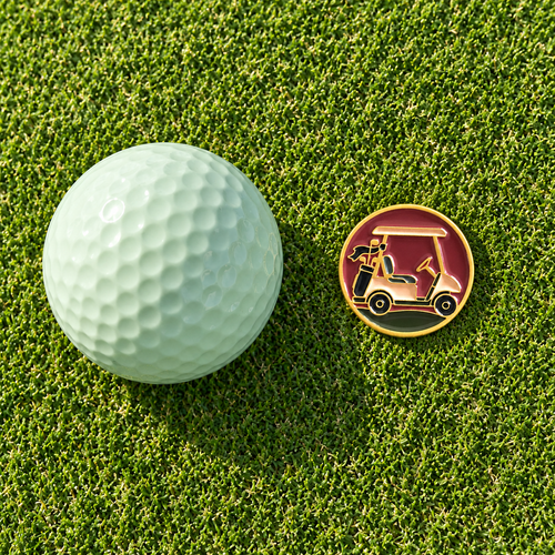 The Shortcut golf ball marker by Fore & Femme on the putting green