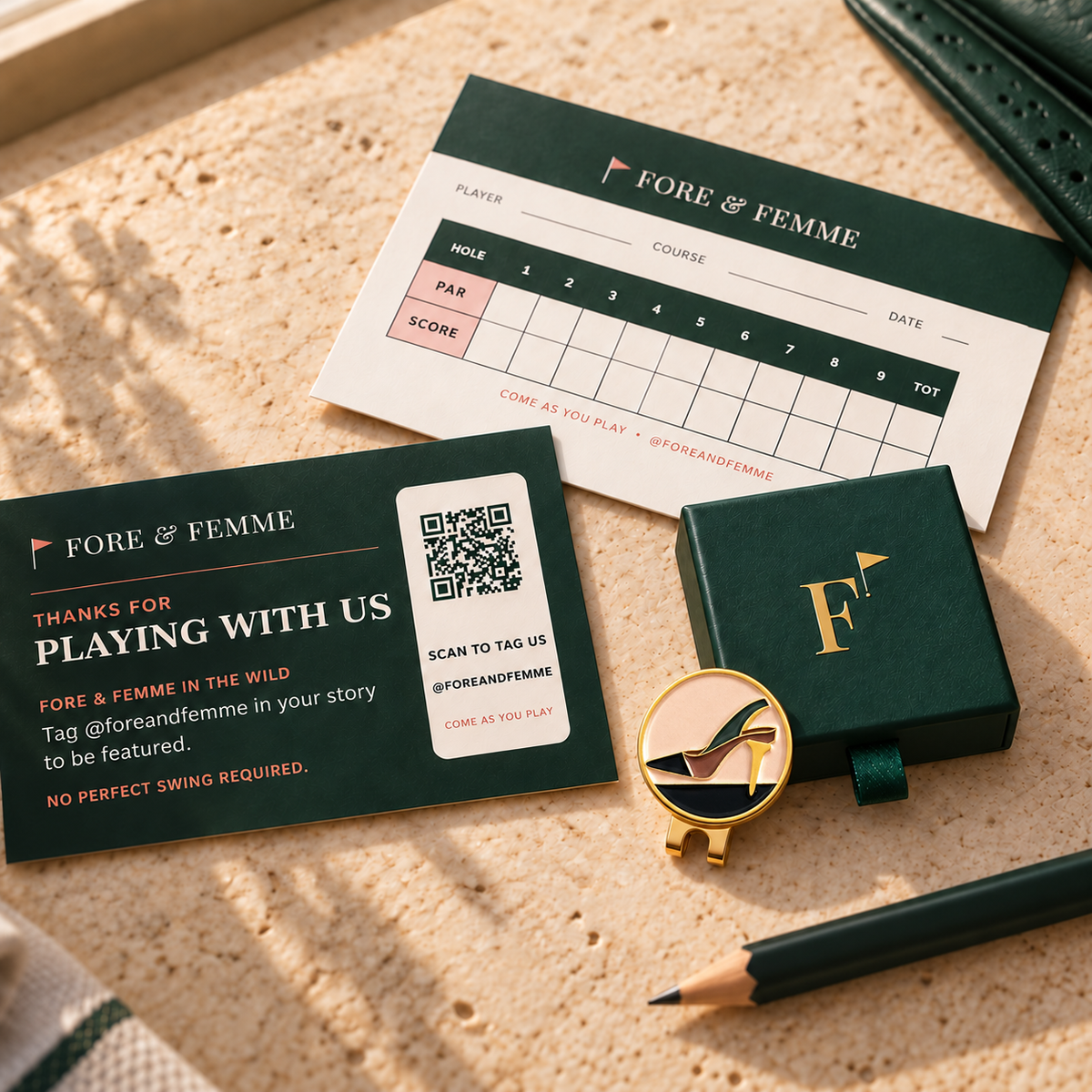 The Tee Heel golf ball marker in its Fore & Femme gift box